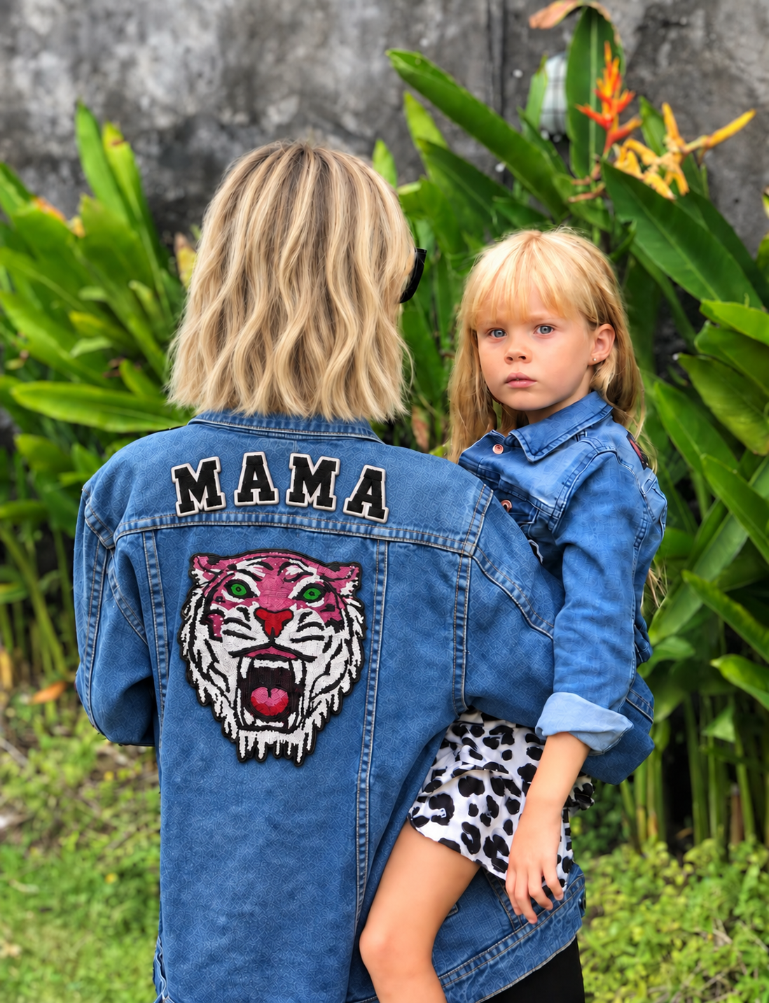Matilda Gyllenhammar in a personalised MAMA denim jacket holding her daughter