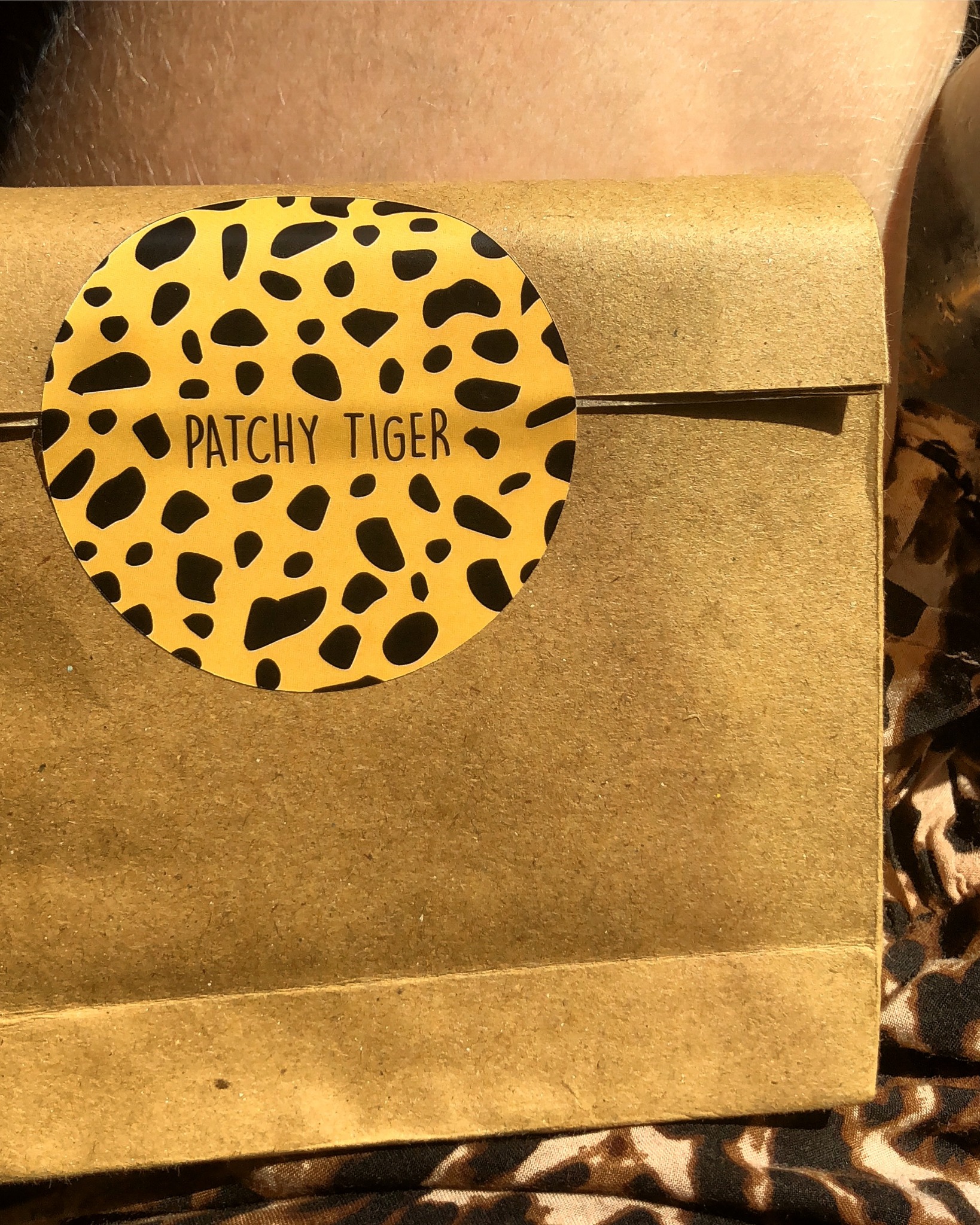 Patchy Tiger kraft packaging with golden spotted brand seal