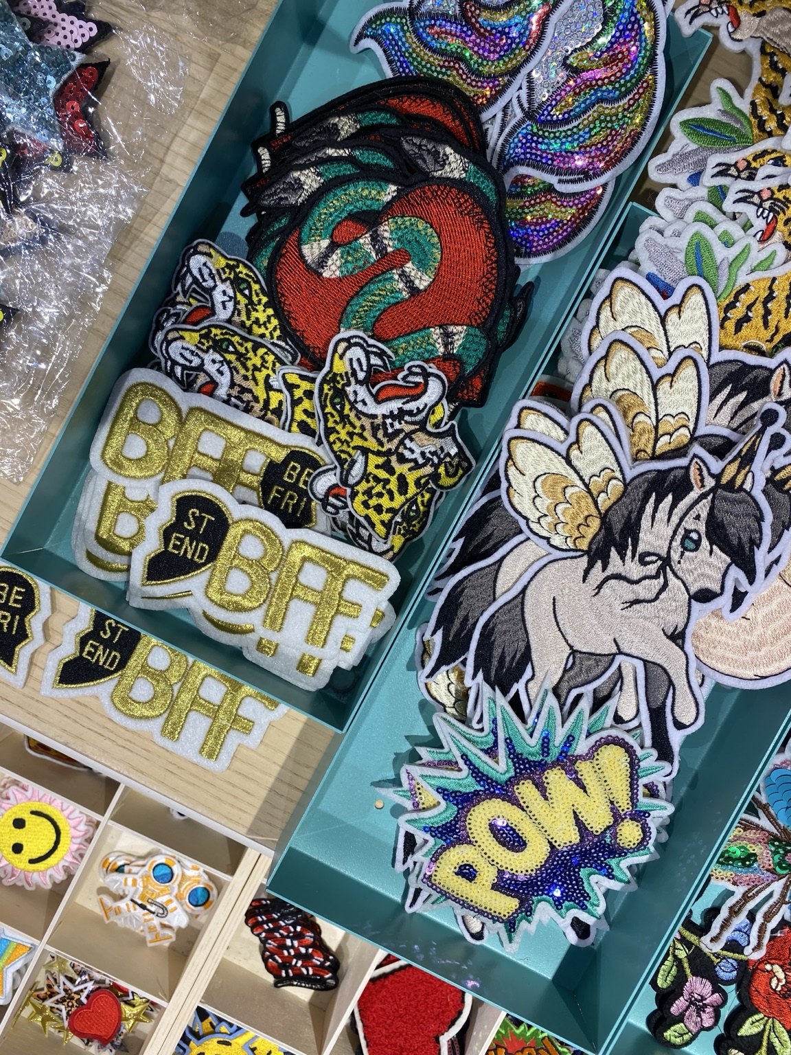 Close-up selection of colourful embroidered patches for visitors to explore