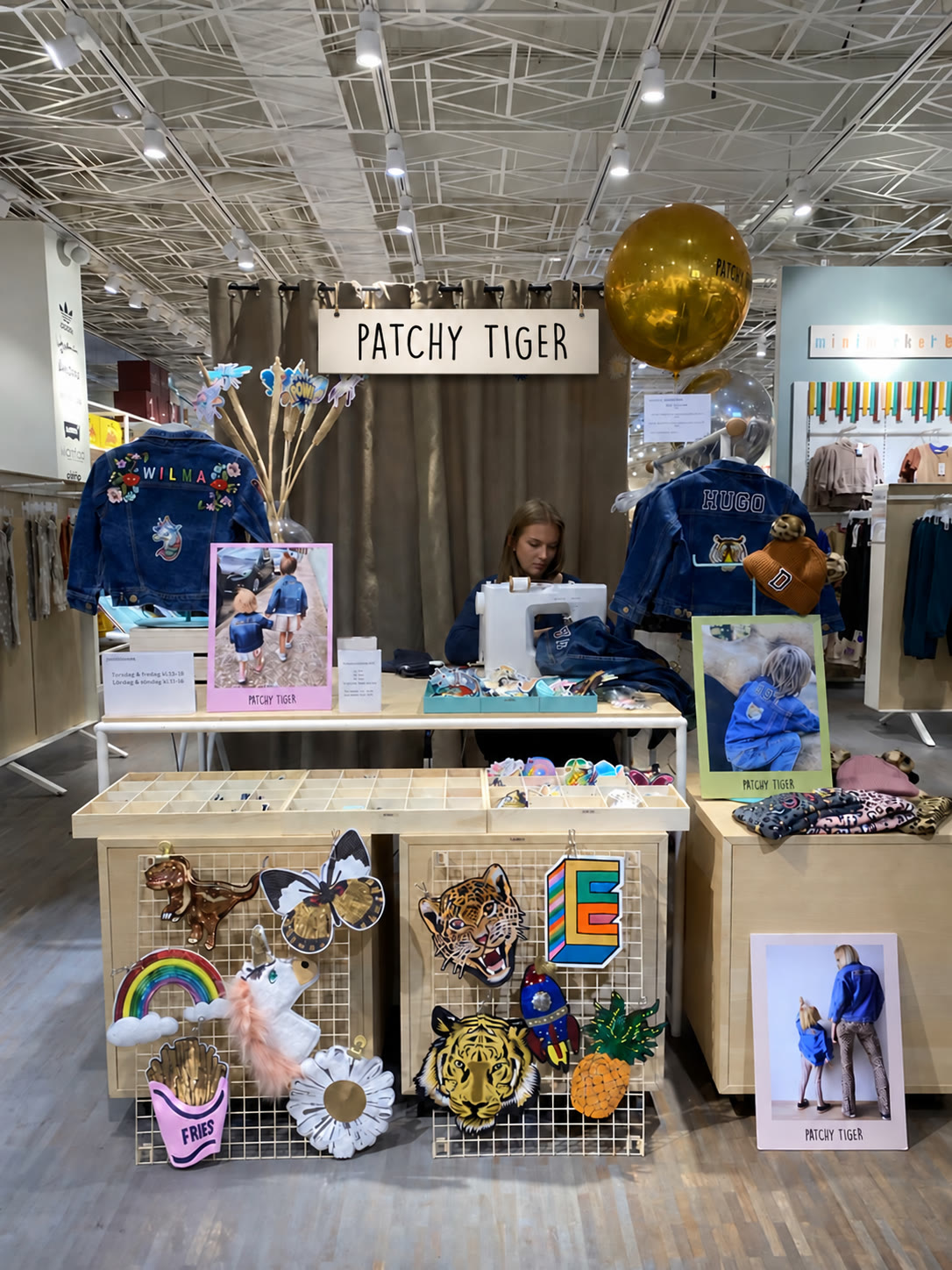 Patchy Tiger pop-up station with a wooden brand sign above personalised denim and patch displays