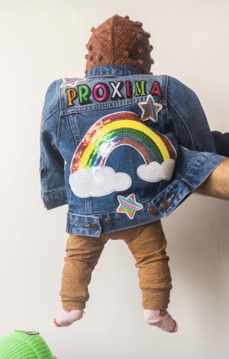 Proxima wearing a personalised Patchy Tiger denim jacket with rainbow patches